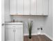 The laundry room features a utility sink, ample storage cabinets, and space for washer and dryer at 17346 Haxby Ln, Westfield, IN 46074