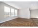 Bright living room with three windows, hardwood floors, and neutral paint offers a versatile living space at 17346 Haxby Ln, Westfield, IN 46074