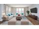 Sunlit living room featuring a plush white sectional, stylish coffee table and soft blue accents at 17346 Haxby Ln, Westfield, IN 46074