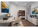 Bright home office complete with modern desk, chair, bookshelf, and stylish decor under recessed lights at 17346 Haxby Ln, Westfield, IN 46074