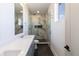 Modern bathroom featuring double sink vanity, modern fixtures, glass shower with marble walls, and black tile flooring at 2053 Columbia Ave, Indianapolis, IN 46202