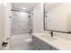 This full bathroom has a tub and shower, toilet, single sink, and white countertops at 2053 Columbia Ave, Indianapolis, IN 46202