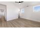 Well lit bedroom with vaulted ceiling, luxury vinyl plank flooring, white trim and hallways leading to other rooms at 2053 Columbia Ave, Indianapolis, IN 46202