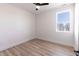 Light-filled bedroom featuring wood floors, ceiling fan, and a large window at 2053 Columbia Ave, Indianapolis, IN 46202