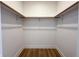Walk-in closet featuring basic rod and shelf system and wood-look flooring at 2053 Columbia Ave, Indianapolis, IN 46202