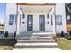 Charming front entrance with two doors, concrete steps, and decorative lighting fixtures at 2053 Columbia Ave, Indianapolis, IN 46202