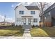 Modern two-story home with white siding, a dark roof, and well-maintained landscaping at 2053 Columbia Ave, Indianapolis, IN 46202
