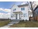 Modern two-story home with white siding, a dark roof, and well-maintained landscaping at 2053 Columbia Ave, Indianapolis, IN 46202