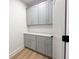 Hallway featuring lots of cabinet space, white walls and wood floors at 2053 Columbia Ave, Indianapolis, IN 46202