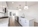Spacious open kitchen with large island, white cabinets, stainless appliances, and pendant lighting at 2053 Columbia Ave, Indianapolis, IN 46202