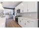 Bright kitchen featuring white cabinets, stainless steel appliances, and hardwood floors at 2053 Columbia Ave, Indianapolis, IN 46202