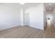 Bright, empty room with wood floor and a door at 2053 Columbia Ave, Indianapolis, IN 46202