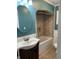 Traditional bathroom featuring tile surround bathtub, vanity, and neutral walls at 212 Walnut St, Greenfield, IN 46140