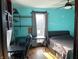 Bedroom with ceiling fan, desk, window, and light teal walls at 212 Walnut St, Greenfield, IN 46140