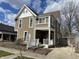 Charming two-story home with tan siding, white trim, and a welcoming front porch at 212 Walnut St, Greenfield, IN 46140