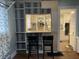 Galley kitchen featuring white cabinets, open shelving, and a pass-through bar at 212 Walnut St, Greenfield, IN 46140