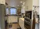 Updated kitchen with white cabinetry, stainless steel appliances, and detailed backsplash at 212 Walnut St, Greenfield, IN 46140