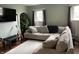 Bright living room features a large sectional sofa, hardwood floors, and natural light from windows at 212 Walnut St, Greenfield, IN 46140