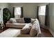 Bright living room features a large sectional sofa, hardwood floors, and natural light from windows at 212 Walnut St, Greenfield, IN 46140