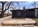 Backyard view showcasing a screened porch, wood deck, and charming landscaping at 24 Thornhurst Dr, Carmel, IN 46032