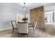 Dining room features a stone accent wall and modern chandelier at 24 Thornhurst Dr, Carmel, IN 46032
