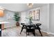 Open concept dining room with modern table, wood flooring, art and decor at 24 Thornhurst Dr, Carmel, IN 46032