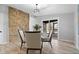 Dining room features a stone accent wall and door to the back yard at 24 Thornhurst Dr, Carmel, IN 46032