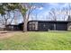 Modern home with dark exterior, large windows, screened porch and a well-maintained lawn at 24 Thornhurst Dr, Carmel, IN 46032