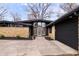Charming single-story home with stone accents, black trim, and a well-maintained front yard at 24 Thornhurst Dr, Carmel, IN 46032