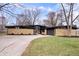 Stunning single-story home with a stone facade and a long driveway leading to an attached garage at 24 Thornhurst Dr, Carmel, IN 46032