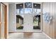 Bright foyer with wood paneling and a view to the exterior through a glass front door at 24 Thornhurst Dr, Carmel, IN 46032
