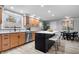 Bright kitchen with wooden cabinets, stainless steel appliances, and a center island with seating at 24 Thornhurst Dr, Carmel, IN 46032