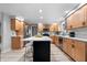 Bright kitchen features stainless steel appliances, wood cabinets and quartz countertops, plus a large island with seating at 24 Thornhurst Dr, Carmel, IN 46032