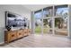 Bright living room with large windows, sleek furniture, wood floors and modern decor at 24 Thornhurst Dr, Carmel, IN 46032