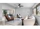 Comfortable living room with modern decor, including wood floors and neutral tones at 24 Thornhurst Dr, Carmel, IN 46032