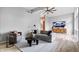 Bright living room with modern decor, gray sofa, ceiling fan, and wooden floors at 24 Thornhurst Dr, Carmel, IN 46032