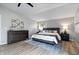 Bright main bedroom with wood floors, large window, and a dresser at 24 Thornhurst Dr, Carmel, IN 46032