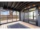 Screened-in porch boasting wood flooring, dark beams, string lights, and an exterior door leading outside at 24 Thornhurst Dr, Carmel, IN 46032