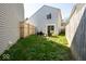 Private backyard with lush lawn, wooden fence, and patio seating at 2421 Grand Fir Dr, Greenwood, IN 46143