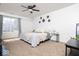 Inviting bedroom featuring large windows, ceiling fan, and decor at 2421 Grand Fir Dr, Greenwood, IN 46143