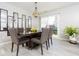 Dining room featuring a modern light fixture, stylish mirrors, and a sliding door to the backyard at 2421 Grand Fir Dr, Greenwood, IN 46143