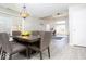 Dining room featuring a modern light fixture, stylish table, and open access to the living room at 2421 Grand Fir Dr, Greenwood, IN 46143