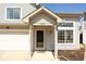 Close up of entrance to the house, highlighting a covered front entryway, bright windows, and fresh landscaping at 2421 Grand Fir Dr, Greenwood, IN 46143