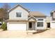 Inviting two-story home featuring a one-car garage, charming front porch, and beautifully maintained landscaping at 2421 Grand Fir Dr, Greenwood, IN 46143