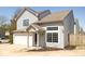 Charming two-story home with a one-car garage and a covered front entryway with bright windows at 2421 Grand Fir Dr, Greenwood, IN 46143