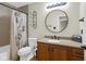 Cozy bathroom featuring a vanity with a round mirror and a shower with patterned curtains at 250 W Tansey Crossing, Westfield, IN 46074