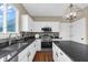 Bright kitchen boasts granite counters, stainless appliances, and a modern light fixture at 250 W Tansey Crossing, Westfield, IN 46074