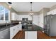 Modern kitchen features granite countertops, stainless appliances, island, and a stylish pendant light at 250 W Tansey Crossing, Westfield, IN 46074