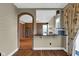 This kitchen features an eat-in bar and adjoins a room through an arched doorway at 250 W Tansey Crossing, Westfield, IN 46074