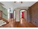 Open concept living space features hardwood floors, brick archways, and neutral paint at 250 W Tansey Crossing, Westfield, IN 46074